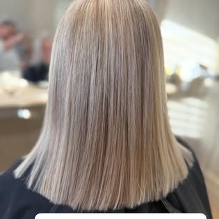 Ash blonde hair colour with a sleek, blunt-cut finish