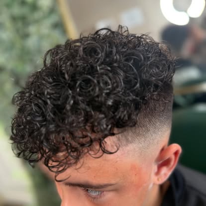 Textured curly cut with a precision faded finish